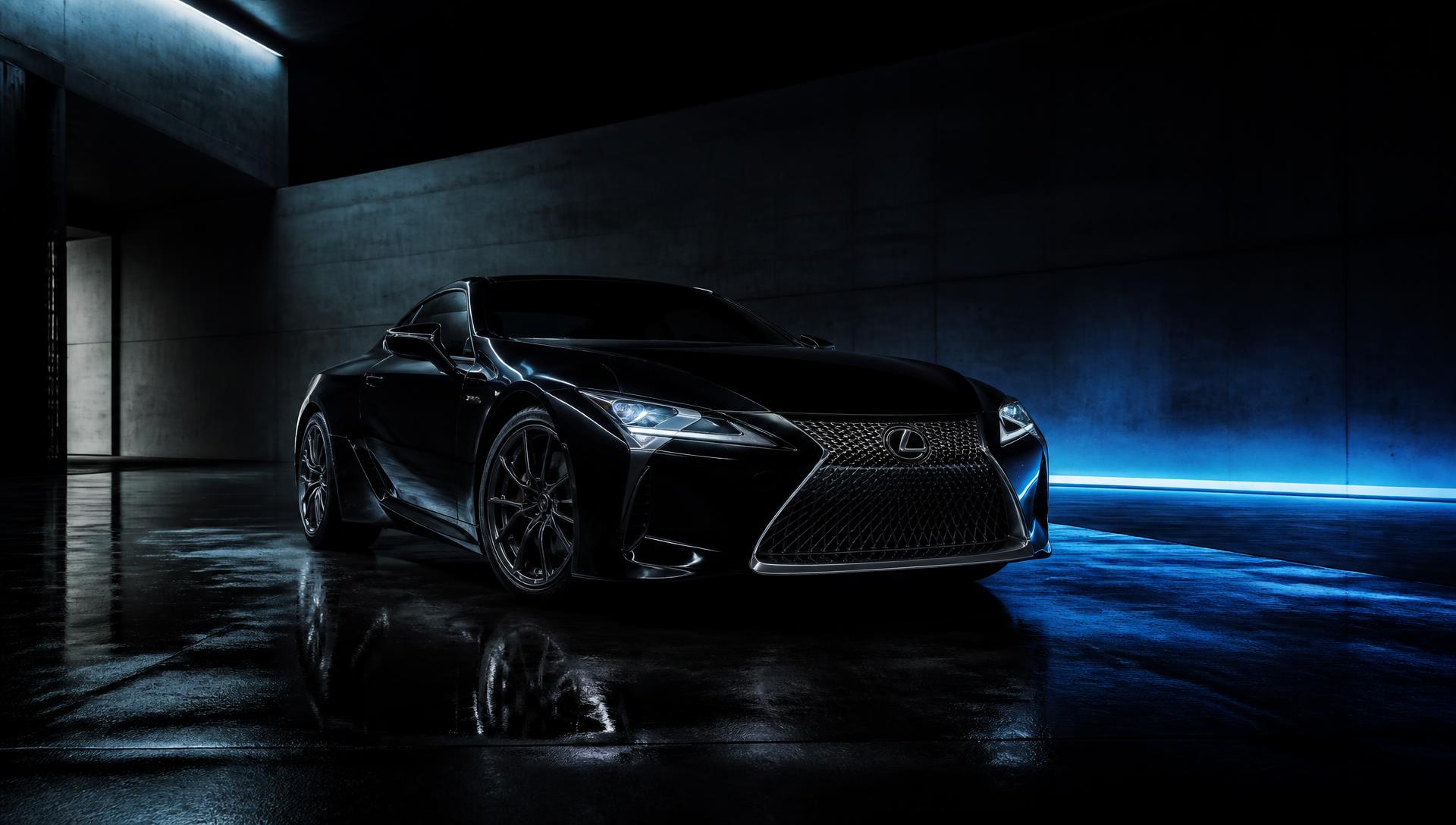 Black luxury coupe in a dark showroom